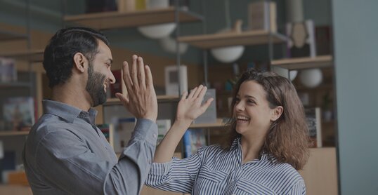 two colleagues high five it jobs timetoact group