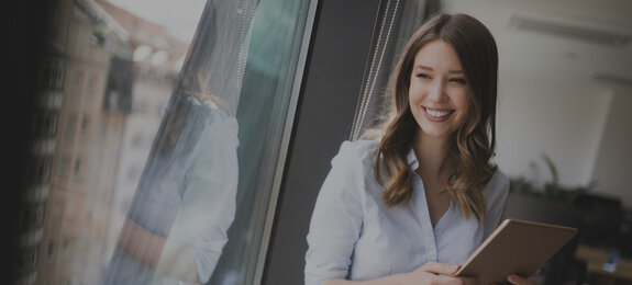 woman on window smiles it jobs timetoact group