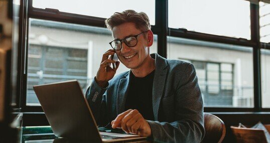 Corporate professional sitting making a phone call