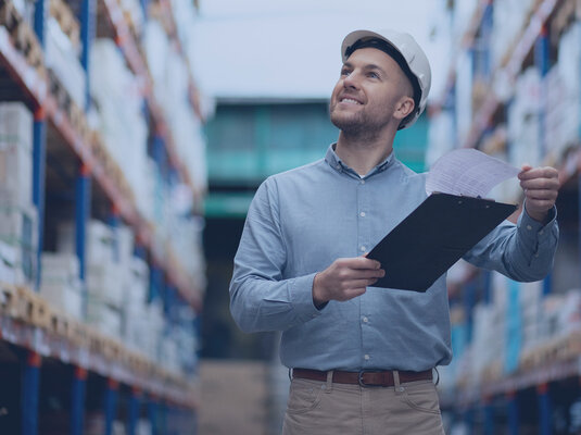 Man walks through a large warehouse